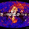 Image left: A giant gamma-ray structure was discovered by processing Fermi all-sky data at energies from 1 to 10 billion electron volts, shown here. The dumbbell-shaped feature (center) emerges from the galactic center and extends 50 degrees north and south from the plane of the Milky Way. (Credit: NASA/DOE/Fermi LAT/D. Finkbeiner et al.)