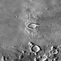 Image right: A double, oblique impact crater on the surface of Mars. Although the origin of such elliptical impact craters on Mars is uncertain, some scientists have determined that the nature of these particular features is best explained by the impact of a former Mars-orbiting moonlet. Potentially many such moonlets were in orbit around Mars at one time, and Phobos and Deimos are the only two surviving objects.
