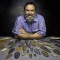 Image left: Dennis Stanford with Clovis stone points from the collection of the Smithsonian's National Museum of Natural History. (Photo by Chip Clark)