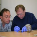 Alain Touwaide and Robert Fleischer examine a phial recovered from the wreckage.