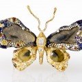 colorful brooch featuring diamonds and in the shape of a butterfly