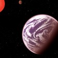 KOI-314c, shown in this artist's conception, is the lightest planet to have both its mass and physical size measured. Surprisingly, although the planet weighs the same as Earth, it is 60 percent larger in diameter, meaning that it must have a very thick, gaseous atmosphere. It orbits a dim, red dwarf star (shown at left) about 200 light-years from Earth. KOI-314c interacts gravitationally with another planet, KOI-314b (shown in the background), causing transit timing variations that allow astronomers to measure the masses of both worlds. This serendipitous discovery resulted from analysis as part of the Hunt for Exomoons with Kepler (HEK) project. (Image by C. Pulliam & D. Aguilar)